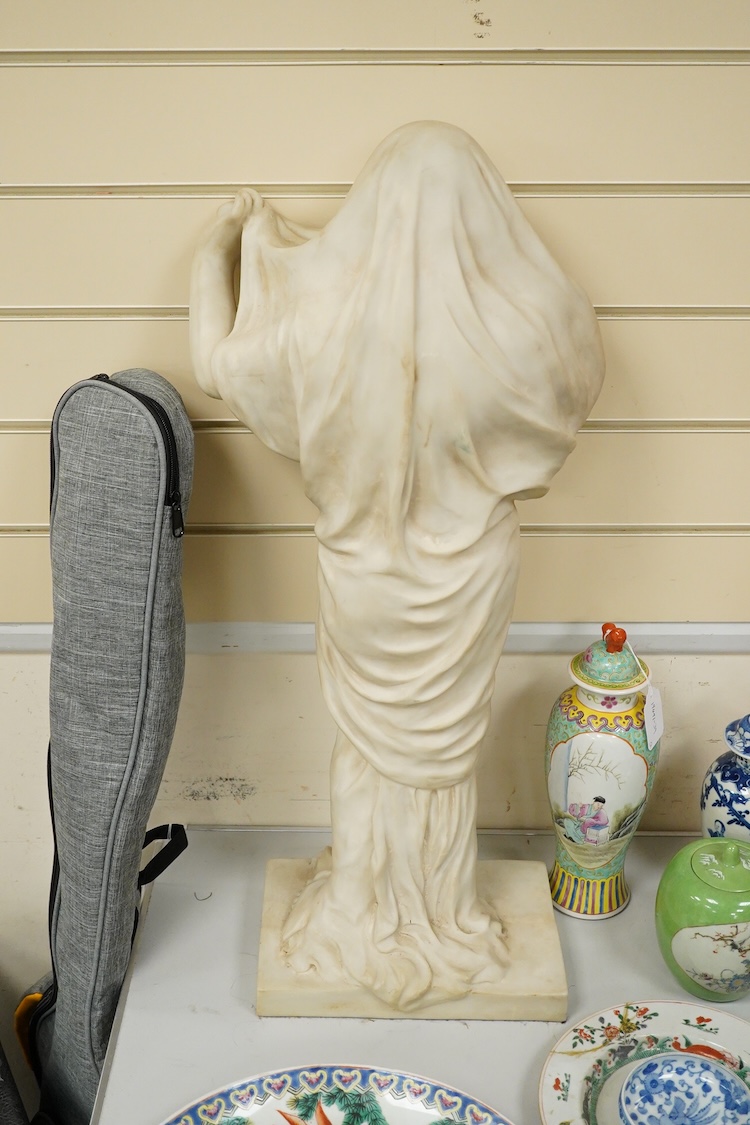 A large simulated marble statuette of a semi nude female, 73cm high